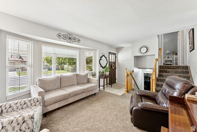 3573 S Deann Dr W, West Valley City, UT 84128 - living area featuring stairs, carpet flooring, a textured ceiling, and tile patterned floors