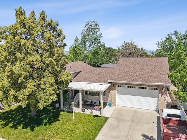 3573 S Deann Dr W, West Valley City, UT 84128 - view of front of property with roof with shingles, a front yard, an attached garage, concrete driveway, and brick siding
