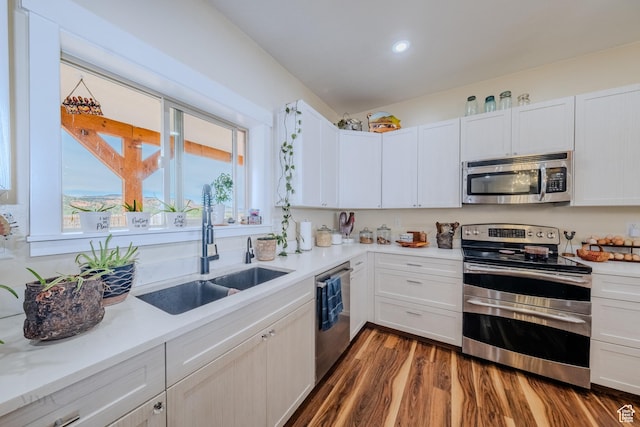 7395 N Johnson Canyon Rd, Kanab, UT 84741 - kitchen with stainless steel appliances, light countertops, dark wood-style floors, white cabinetry, and recessed lighting