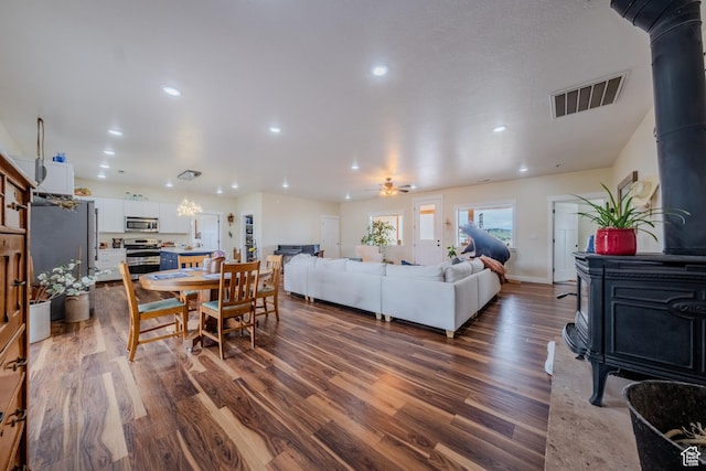 7395 N Johnson Canyon Rd, Kanab, UT 84741 - living room featuring a wood stove, dark wood-style floors, recessed lighting, and ceiling fan