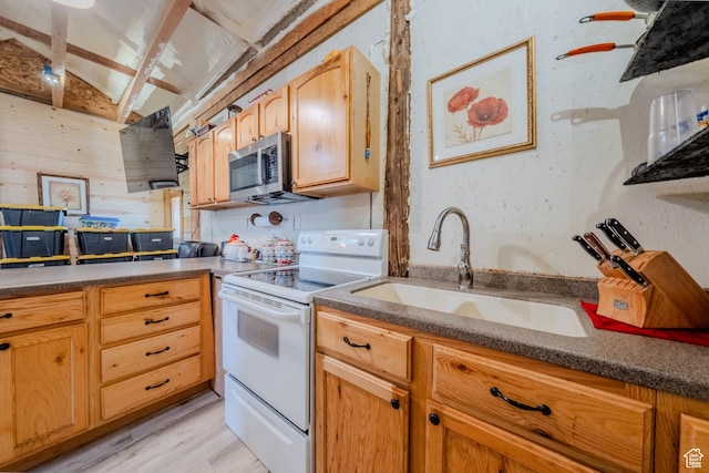 7395 N Johnson Canyon Rd, Kanab, UT 84741 - kitchen with electric stove, stainless steel microwave, light wood-type flooring, and dark countertops