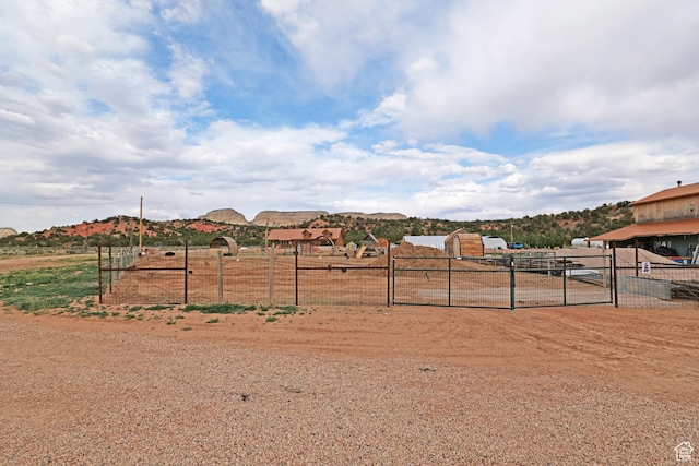 7395 N Johnson Canyon Rd, Kanab, UT 84741 - view of yard with a gate, a mountain view, and a view of rural / pastoral area
