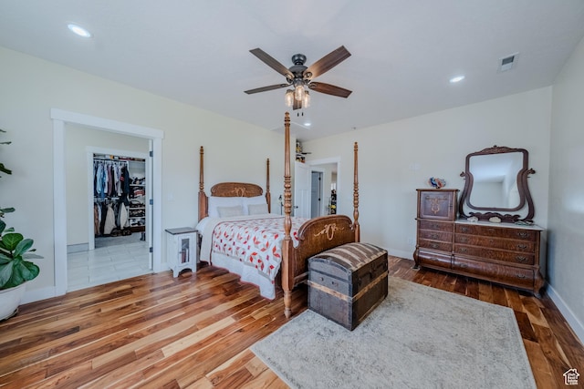 7395 N Johnson Canyon Rd, Kanab, UT 84741 - bedroom with wood finished floors, ceiling fan, a walk in closet, and recessed lighting