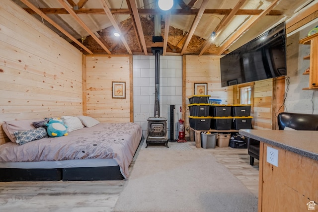 7395 N Johnson Canyon Rd, Kanab, UT 84741 - bedroom with wooden walls, a wood stove, and carpet