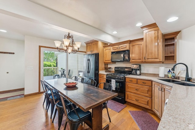 171 Dunlop Ct, Park City, UT 84060 - kitchen with black appliances, light wood-style flooring, light countertops, a chandelier, and decorative light fixtures