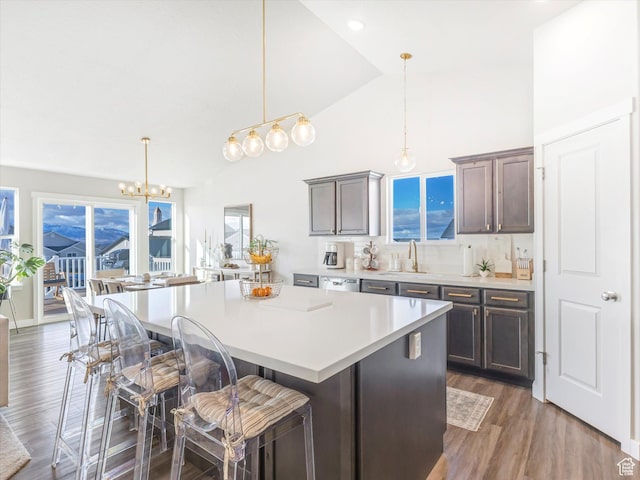 2297 N 250 W, Tooele, UT 84074 - kitchen featuring stainless steel dishwasher, a center island, light countertops, a breakfast bar area, and a chandelier