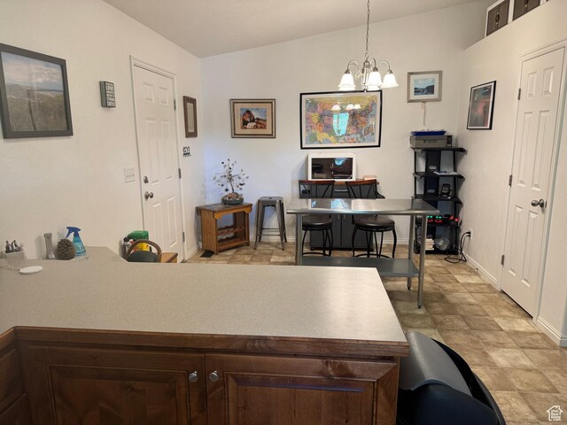 580 E Main St, Myton, UT 84052 - kitchen with a desk, a chandelier, dark brown cabinetry, decorative light fixtures, and a peninsula