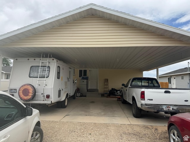 580 E Main St, Myton, UT 84052 - view of parking / parking lot featuring an attached carport and driveway