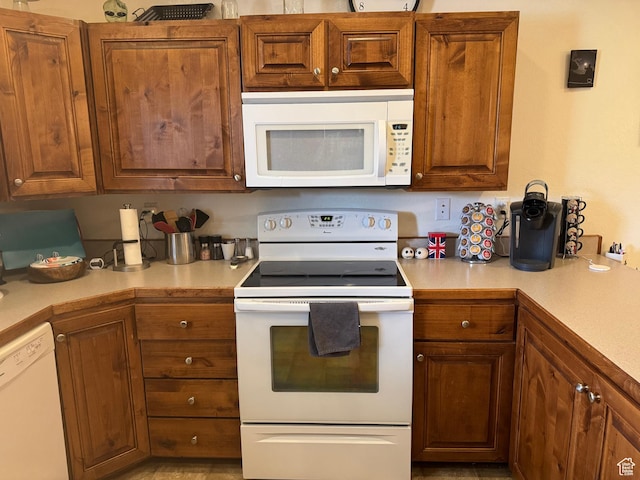 580 E Main St, Myton, UT 84052 - kitchen featuring white appliances, light countertops, and brown cabinets