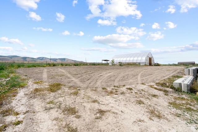 18605 N 6000 W, Riverside, UT 84334 - view of yard with a view of countryside, an exterior structure, an outbuilding, and a mountain view