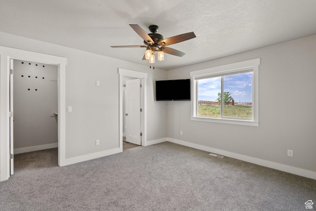 18605 N 6000 W, Riverside, UT 84334 - unfurnished bedroom featuring a spacious closet, carpet, and ceiling fan