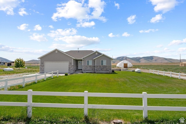 18605 N 6000 W, Riverside, UT 84334 - single story home featuring a fenced front yard, a mountain view, a garage, and a view of rural / pastoral area