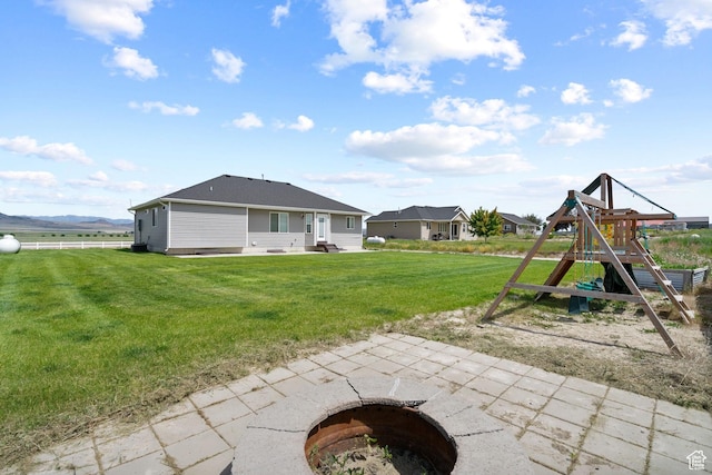 18605 N 6000 W, Riverside, UT 84334 - rear view of house featuring a playground, a yard, and a patio