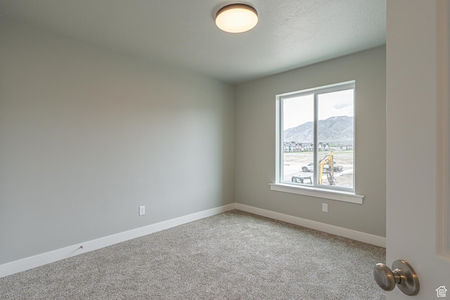 2202 S 1120 W Unit 64, Nibley, UT 84321 - carpeted empty room featuring a mountain view and baseboards