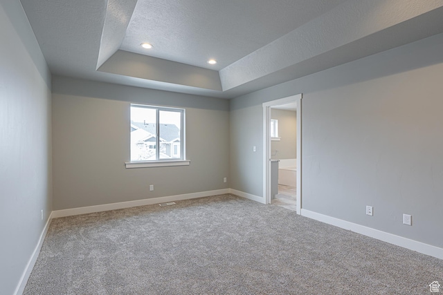 2202 S 1120 W Unit 64, Nibley, UT 84321 - spare room with a textured ceiling, a raised ceiling, light carpet, and recessed lighting