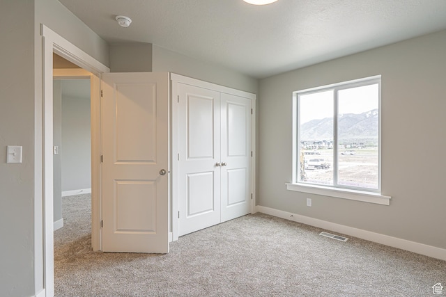 2202 S 1120 W Unit 64, Nibley, UT 84321 - unfurnished bedroom with light colored carpet, a mountain view, and a closet