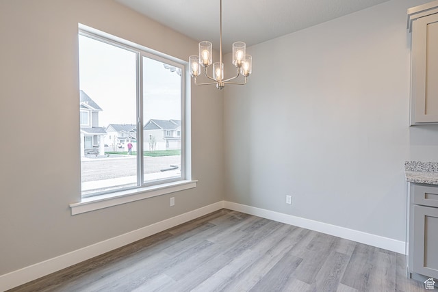 2202 S 1120 W Unit 64, Nibley, UT 84321 - unfurnished dining area with a chandelier and light wood-style flooring