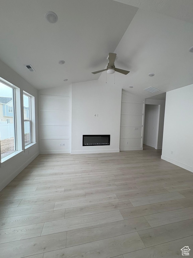 968 W 880 N Unit 59, Tremonton, UT 84337 - unfurnished living room with lofted ceiling, a ceiling fan, light wood finished floors, and a fireplace