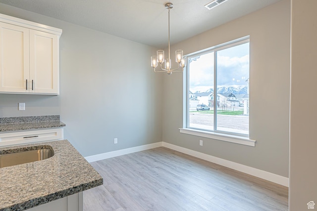 2206 S 1120 W Unit 65, Nibley, UT 84321 - unfurnished dining area with healthy amount of natural light, light wood-style flooring, and a chandelier