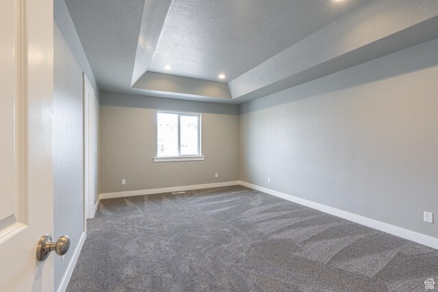 2206 S 1120 W Unit 65, Nibley, UT 84321 - spare room with a textured ceiling, dark colored carpet, a tray ceiling, and recessed lighting