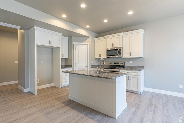 2206 S 1120 W Unit 65, Nibley, UT 84321 - kitchen with appliances with stainless steel finishes, light wood-style flooring, white cabinetry, and recessed lighting