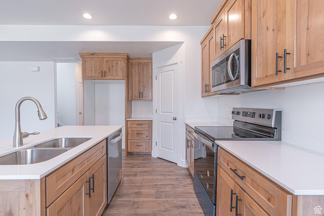 2214 S 1120 W Unit 67, Nibley, UT 84321 - kitchen featuring stainless steel appliances, wood finished floors, recessed lighting, light countertops, and light brown cabinets
