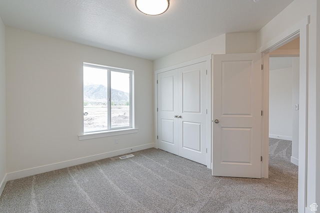 2214 S 1120 W Unit 67, Nibley, UT 84321 - unfurnished bedroom featuring carpet flooring, a mountain view, and a closet