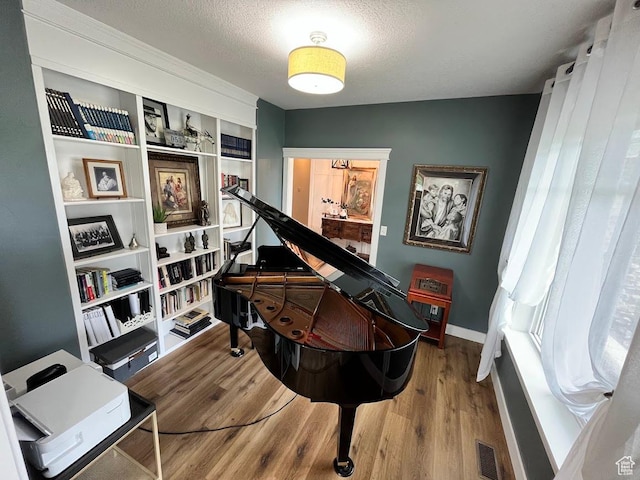 4053 W 3770 S, Wellsville, UT 84339 - living area featuring wood finished floors, a textured ceiling, and built in shelves