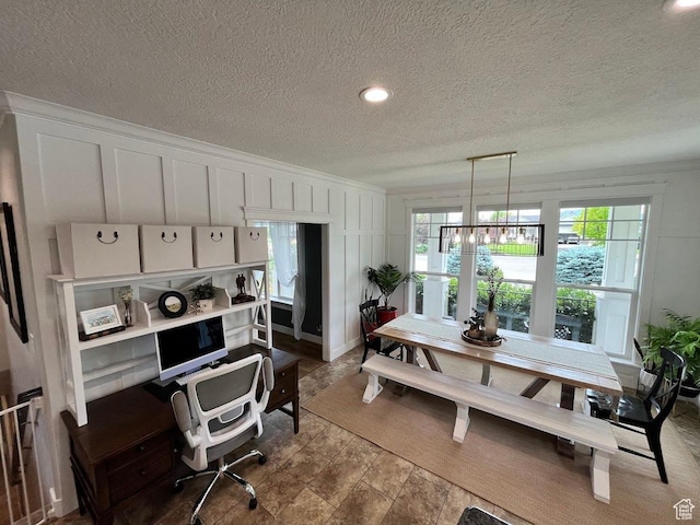 4053 W 3770 S, Wellsville, UT 84339 - dining area with a decorative wall, a desk, and a textured ceiling