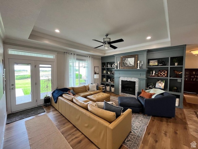 4053 W 3770 S, Wellsville, UT 84339 - living area featuring a raised ceiling, ornamental molding, wood finished floors, a fireplace, and a ceiling fan