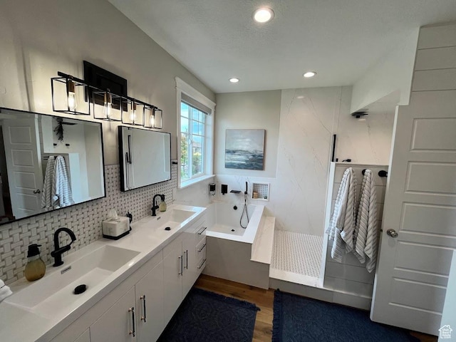 4053 W 3770 S, Wellsville, UT 84339 - full bathroom featuring wood finished floors, a tub with jets, double vanity, backsplash, and recessed lighting