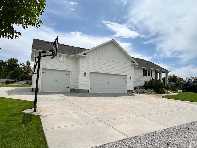 4053 W 3770 S, Wellsville, UT 84339 - view of front of home featuring a garage, concrete driveway, board and batten siding, and roof with shingles