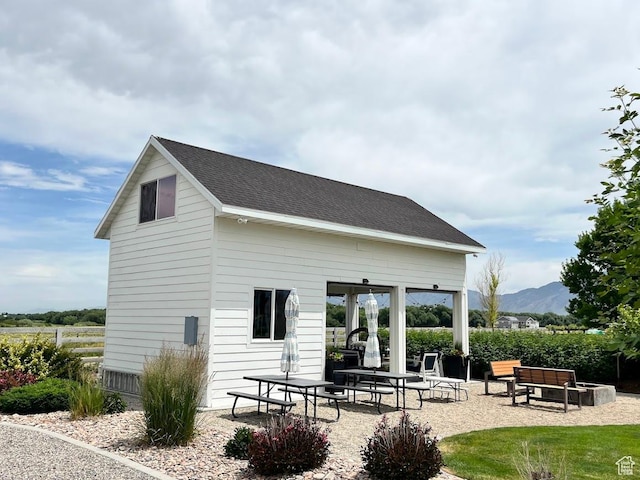 4053 W 3770 S, Wellsville, UT 84339 - back of house featuring a patio, a mountain view, and roof with shingles
