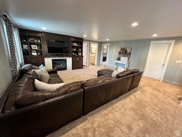 4053 W 3770 S, Wellsville, UT 84339 - living area with light colored carpet, a glass covered fireplace, recessed lighting, and a decorative wall