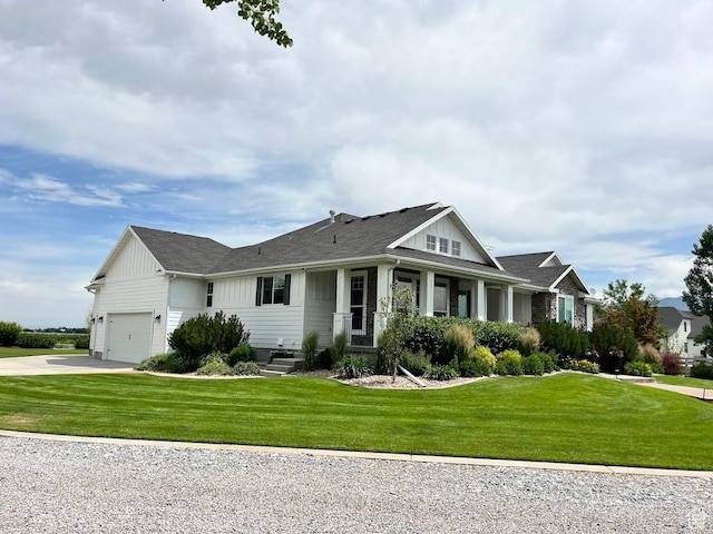 4053 W 3770 S, Wellsville, UT 84339 - view of front facade featuring board and batten siding, concrete driveway, a front lawn, and an attached garage