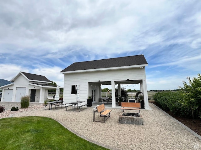 4053 W 3770 S, Wellsville, UT 84339 - back of property featuring an outdoor fire pit, an outdoor structure, and a patio area