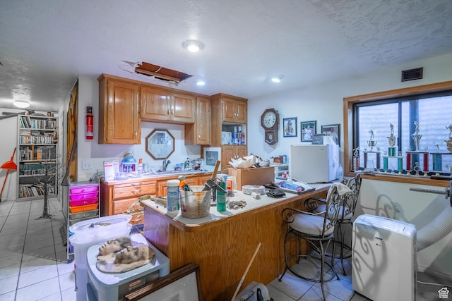 737 Carma Way, Washington, UT 84780 - kitchen with light tile patterned floors, light countertops, a desk, recessed lighting, and a kitchen breakfast bar