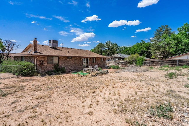 737 Carma Way, Washington, UT 84780 - rear view of property featuring a chimney and brick siding