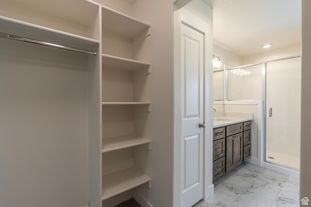 2281 S 1050 W Unit 97, Nibley, UT 84321 - full bath featuring vanity, a shower stall, marble finish floors, a walk in closet, and recessed lighting