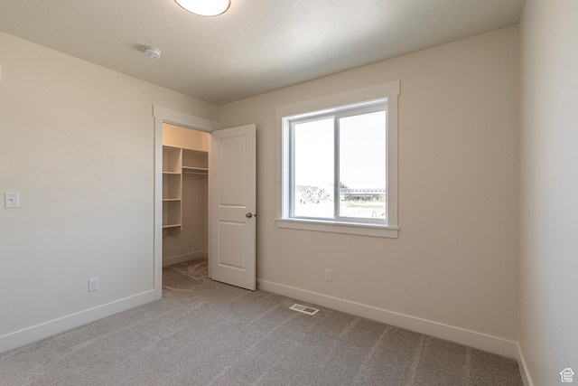 2281 S 1050 W Unit 97, Nibley, UT 84321 - unfurnished bedroom featuring carpet floors, a walk in closet, and a closet
