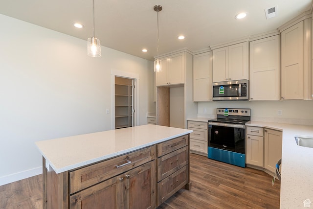 2281 S 1050 W Unit 97, Nibley, UT 84321 - kitchen featuring appliances with stainless steel finishes, dark wood-style flooring, light stone countertops, hanging light fixtures, and a center island