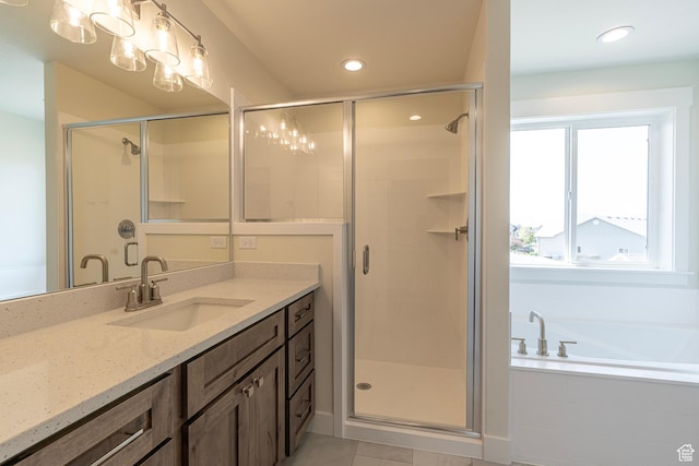2281 S 1050 W Unit 97, Nibley, UT 84321 - bathroom featuring vanity, a stall shower, a bath, tile patterned flooring, and recessed lighting
