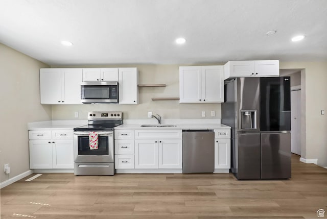 6033 S 2100 W, Roy, UT 84067 - kitchen with stainless steel appliances, white cabinetry, light countertops, recessed lighting, and light wood-style floors