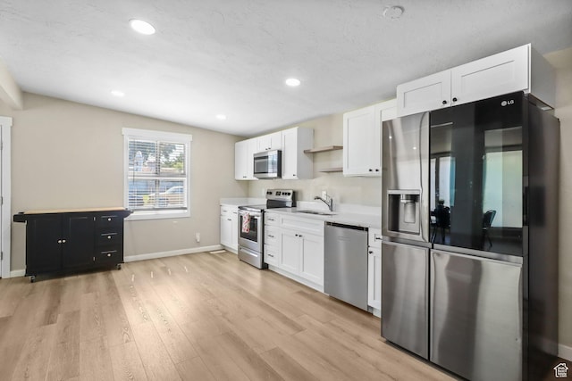 6033 S 2100 W, Roy, UT 84067 - kitchen featuring stainless steel appliances, white cabinets, light wood finished floors, light countertops, and recessed lighting