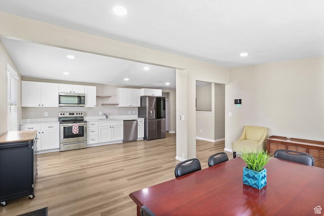 6033 S 2100 W, Roy, UT 84067 - dining room featuring light wood-type flooring and recessed lighting