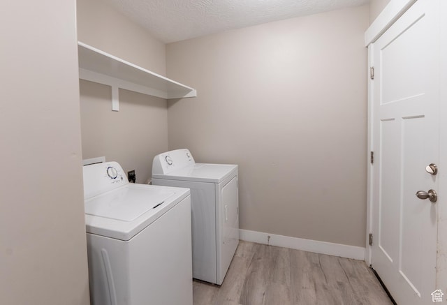 3867 N Chapman Dr, Eagle Mountain, UT 84005 - laundry room featuring washer and dryer, light wood finished floors, and a textured ceiling