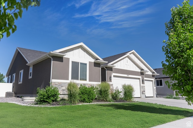 3867 N Chapman Dr, Eagle Mountain, UT 84005 - ranch-style home with stone siding, a front lawn, a garage, concrete driveway, and stucco siding
