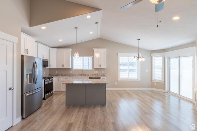 3867 N Chapman Dr, Eagle Mountain, UT 84005 - kitchen featuring appliances with stainless steel finishes, a kitchen island, vaulted ceiling, white cabinetry, and ceiling fan