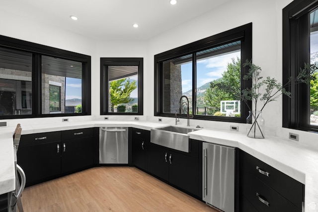 1643 E Box Elder Dr, Alpine, UT 84004 - kitchen with dark cabinetry, appliances with stainless steel finishes, light countertops, healthy amount of natural light, and recessed lighting