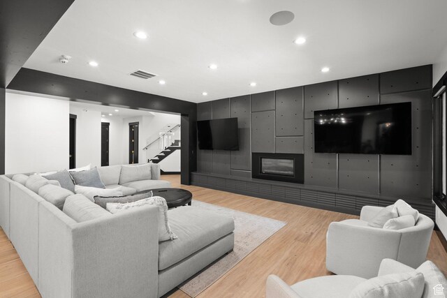 1643 E Box Elder Dr, Alpine, UT 84004 - living area with stairway, light wood finished floors, recessed lighting, and a glass covered fireplace